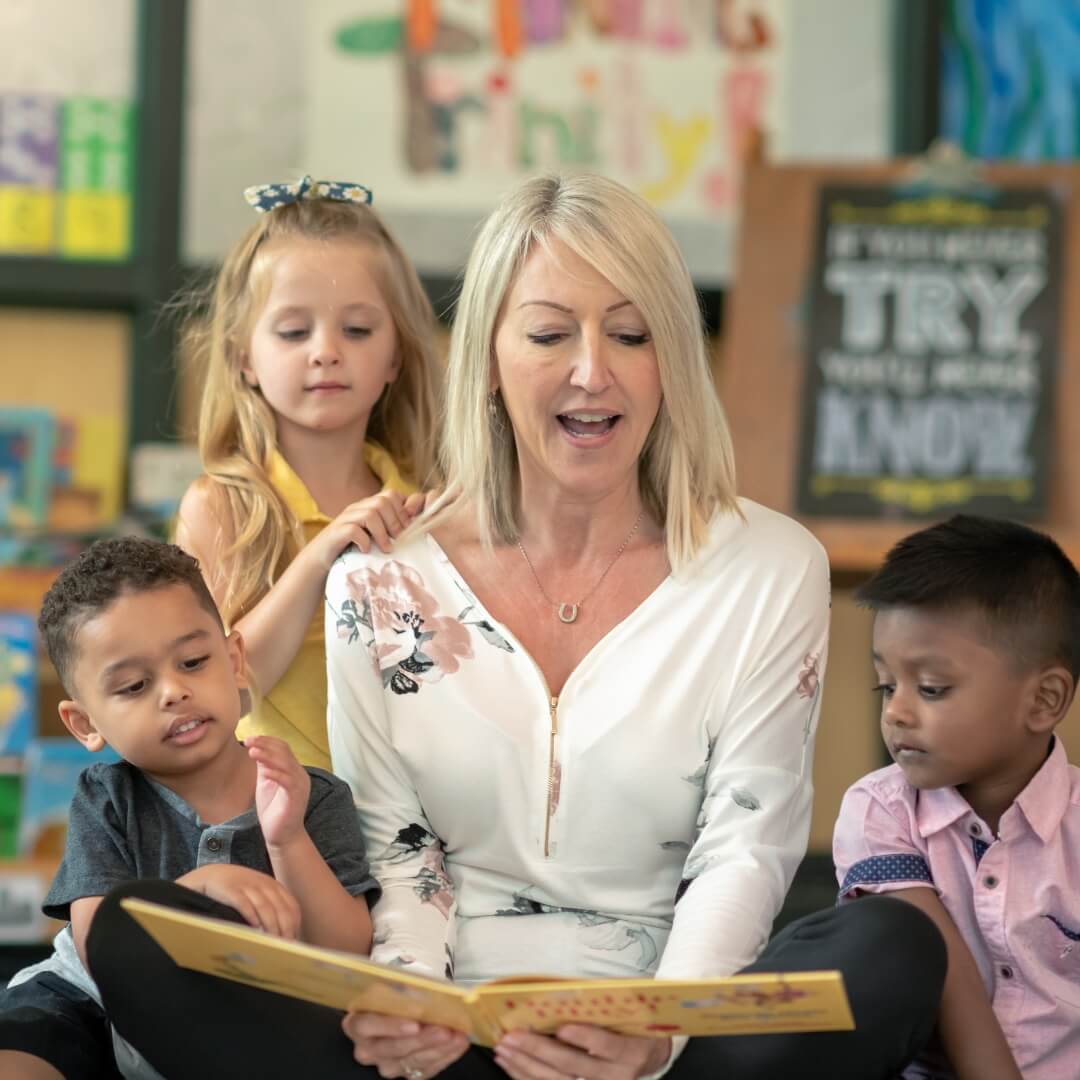 Teacher reading to a group of young children