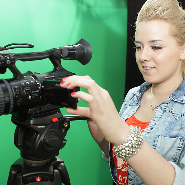 A young woman looking into a cam recorder.
